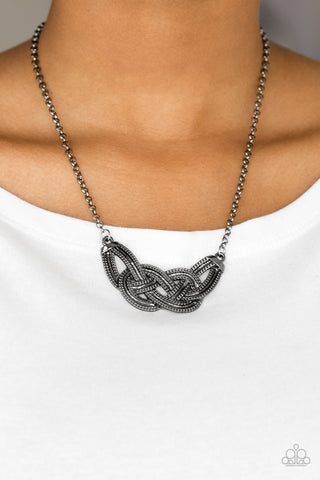 Nautically Naples - Black Necklace - Paparazzi Accessories Featuring chain-like patterns, antiqued gunmetal bars knot below the collar for a bold industrial look. Features an adjustable clasp closure.  Sold as one individual necklace. Includes one pair of matching earrings.