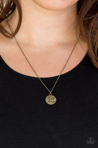 Find Joy - Brass Necklace - Paparazzi Accessories Stamped in the inspirational phrase, "find joy in the journey," a round brass pendant swings below the collar for a seasonal look. Features an adjustable clasp closure.  Sold as one individual necklace. Includes one pair of matching earrings.  New Kit