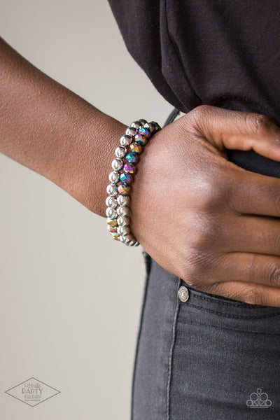 Chroma Color - Multi Bracelet - Paparazzi Accessories Dipped in a rainbow iridescence, a collection of metallic crystal-like beads and shiny silver beads are threaded along two stretchy bands around the wrist for a stellar look.  Sold as one set of two bracelets.  New Kit FANFAVORITE