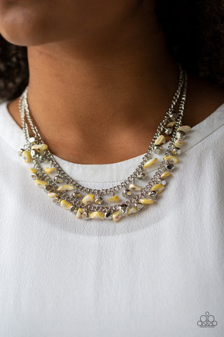 Pebble Pioneer - Yellow Necklace - Paparazzi Accessories Two strands of iridescent yellow pebbles and faceted silver beads swing from the bottoms of two layered chains, creating a colorful fringe below the collar. Features an adjustable clasp closure.  Sold as one individual necklace. Includes one pair of matching earrings.