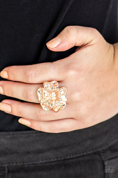 Tropical Gardens - Rose Gold Ring - Paparazzi Accessories Brushed in a high-sheen shimmer, glistening rose gold petals fold into a tropical inspired flower atop the finger for a seasonal flair. Features a stretchy band for a flexible fit.  Sold as one individual ring.