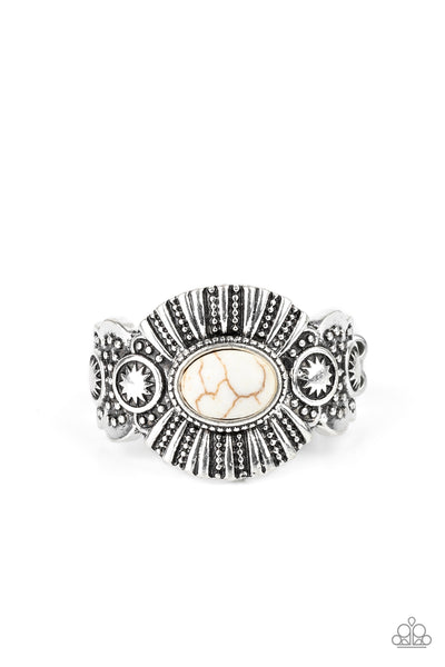 Thirst Quencher - White Ring - Paparazzi Accessories An oval white stone is pressed into the center of an ornate silver frame radiating with linear and sunburst patterns for a seasonal flair. Features a dainty stretchy band for a flexible fit.  Sold as one individual ring.