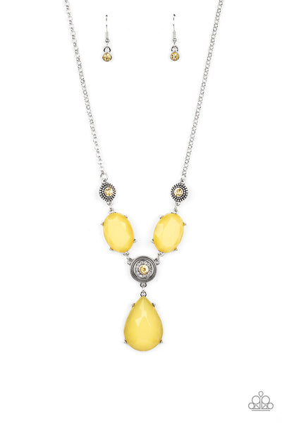 Heirloom Hideaway - Yellow Necklace - Paparazzi Accessories A collection of yellow and white rhinestone dotted silver frames link with a pair of dewy yellow oval gems below the collar. A dramatically oversized dewy yellow teardrop drips from the center, creating a glamorous pendant. Features an adjustable clasp closure.  Sold as one individual necklace. Includes one pair of matching earrings.  New Kit