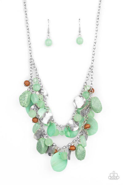 Spring Goddess - Green Necklace - Paparazzi Accessories Infused with wooden beads and silver discs, an earthy collection of glassy, opaque, and shell-like Green Ash beads swing from two silver chains. The refreshing display effortlessly layers below the collar, creating a springtime inspired fringe. Features an adjustable clasp closure.  Sold as one individual necklace. Includes one pair of matching earrings.   New Kit