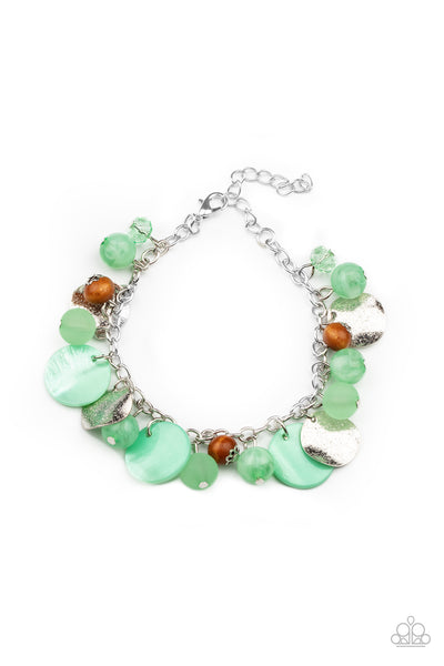 Springtime Springs - Green Bracelet - Paparazzi Accessories Infused with wooden beads and silver discs, an earthy collection of glassy, opaque, and shell-like Green Ash beads swing from the wrist, creating a springtime inspired fringe. Features an adjustable clasp closure.  Sold as one individual bracelet.   New Kit