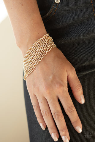 I Woke Up Like This - Gold Bracelet - Paparazzi Accessories Strung between two gold fittings, sparkly strand after sparkly strand of glittery white rhinestones layer around the wrist, creating a glamorous statement piece. Features an adjustable clasp closure.  Sold as one individual bracelet.  New Kit