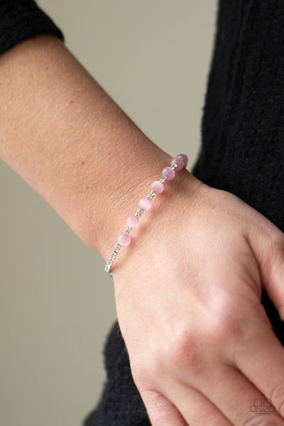 Tea Party Twinkle - Pink Bracelet - Paparazzi Accessories  Glassy pink cat's eye stones are fitted in place along a dainty strand of glassy white rhinestones, creating a twinkly cuff around the wrist.  Sold as one individual bracelet.  New Kit