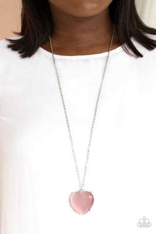 Warmhearted Glow - Pink Necklace - Paparazzi Accessories An oversized pink cat's eye stone frame swings from the bottom of a lengthened silver chain, creating a flirtatious pendant. Features an adjustable clasp closure.  Sold as one individual necklace. Includes one pair of matching earrings.  New Kit