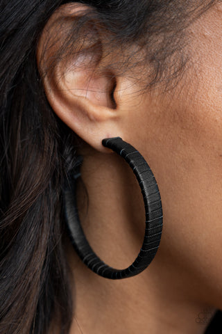 Leather-Clad Legend - Black Hoop Earrings - Paparazzi Accessories A black leather lace wraps around a thick silver hoop, creating an edgy display. Earring attaches to a standard post fitting. Hoop measures approximately 2 1/2" in diameter.  Sold as one pair of hoop earrings.  New Kit