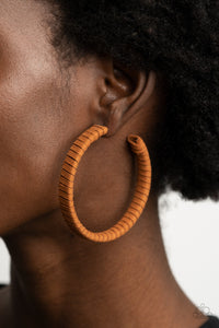 Suede Parade - Brown Earrings - Paparazzi Accessories Tan suede cording wraps around an oversized hoop, creating an earthy pop of color. Earring attaches to a standard post fitting. Hoop measures approximately 2 1/4" in diameter.  Sold as one pair of hoop earrings.  New Kit