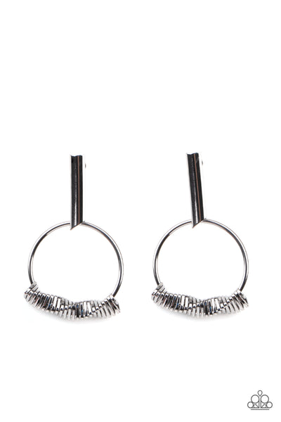 Set Into Motion - Black Earrings - Paparazzi Accessories Glistening gunmetal triangular rings are delicately fitted in place along the bottom of a dainty gunmetal hoop, creating the illusion of twisting movement. The edgy hoop links to a gunmetal rectangular hoop, creating an edgy lure. Earring attaches to a standard post fitting.  Sold as one pair of post earrings.  New Kit