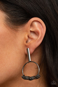 Set Into Motion - Black Earrings - Paparazzi Accessories Glistening gunmetal triangular rings are delicately fitted in place along the bottom of a dainty gunmetal hoop, creating the illusion of twisting movement. The edgy hoop links to a gunmetal rectangular hoop, creating an edgy lure. Earring attaches to a standard post fitting.  Sold as one pair of post earrings.  New Kit