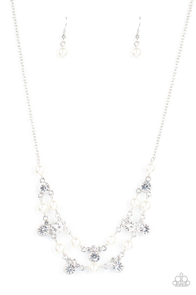 Royal Announcement - White Necklace - Paparazzi Accessories A bubbly collection of white pearls and glassy white rhinestones delicately connect into two timeless rows below the collar, creating a stunning statement piece. Features an adjustable clasp closure.  Sold as one individual necklace. Includes one pair of matching earrings.  New Kit