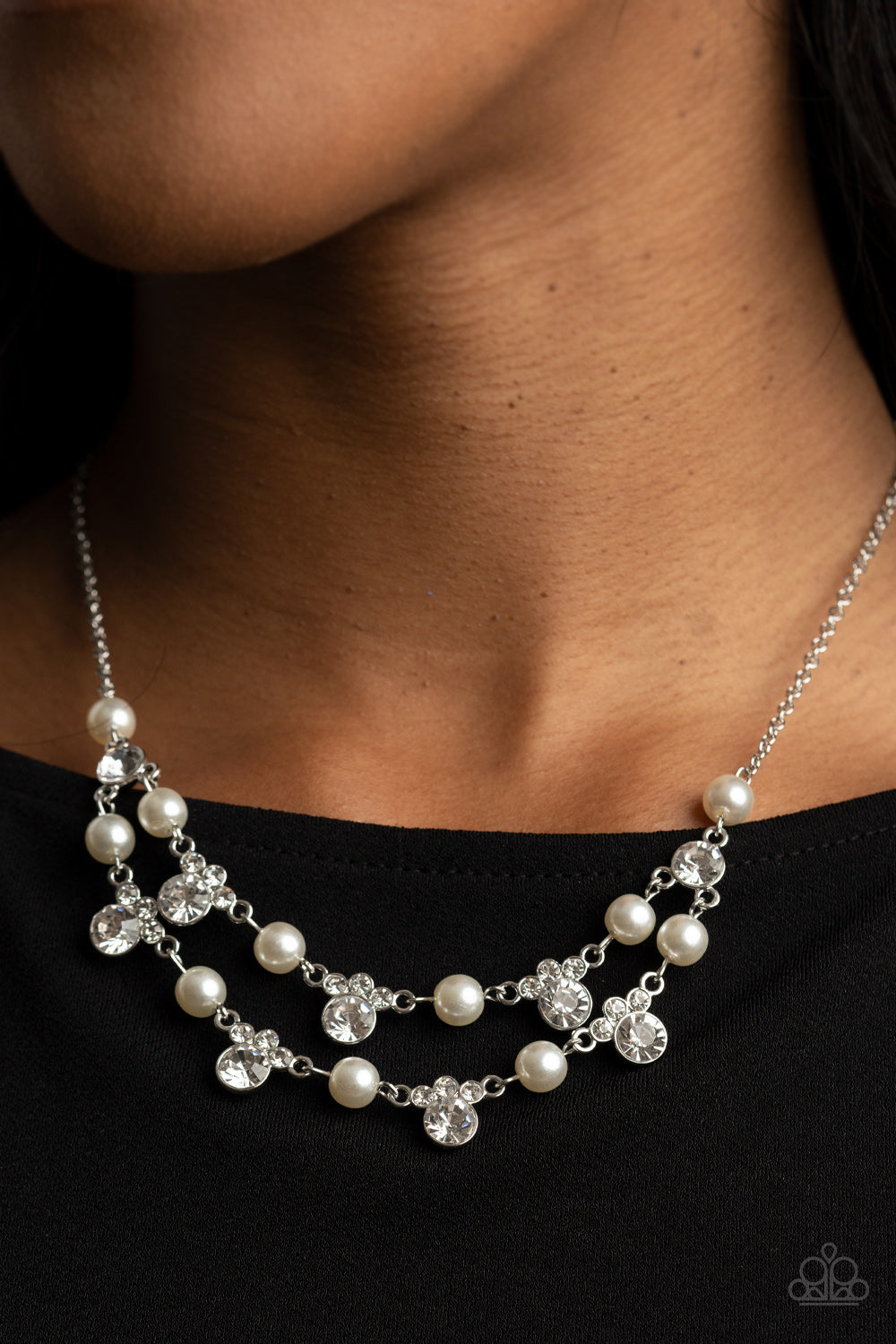 Royal Announcement - White Necklace - Paparazzi Accessories A bubbly collection of white pearls and glassy white rhinestones delicately connect into two timeless rows below the collar, creating a stunning statement piece. Features an adjustable clasp closure.  Sold as one individual necklace. Includes one pair of matching earrings.  New Kit