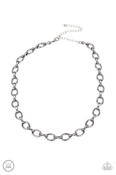 Craveable Couture - Black Choker Necklace - Paparazzi Accessories A collection of oversized gunmetal ovals and glistening gunmetal fittings interlock around the neck, creating an intense industrial look. Features an adjustable clasp closure.  Sold as one individual choker necklace. Includes one pair of matching earrings.  New Kit Choker