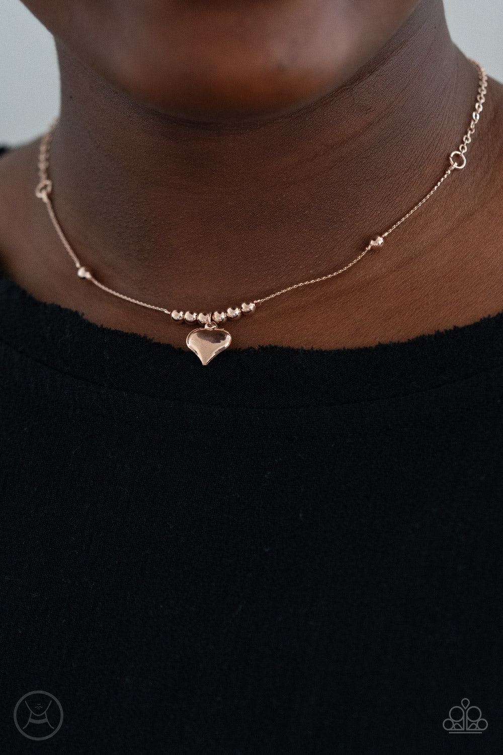 Casual Crush - Rose Gold Choker Necklace - Paparazzi Accessories Infused with dainty rose gold beads, a charming rose gold heart dangles from a wire-like chain around the neck for a flirtatious look. Features an adjustable clasp closure.  Sold as one individual choker necklace. Includes one pair of matching earrings.  New Kit Choker