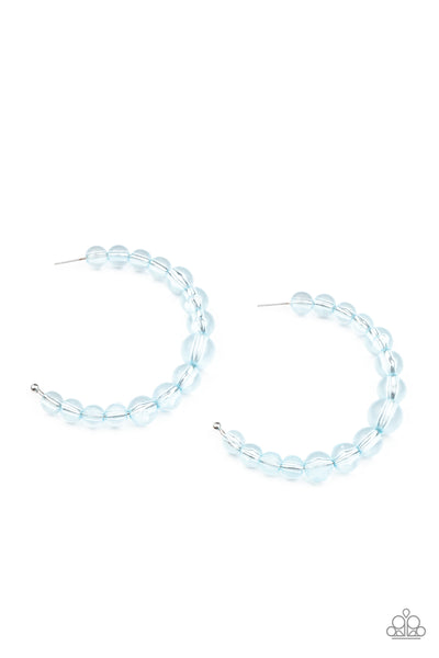 In The Clear - Blue Earrings - Paparazzi Accessories Gradually increasing in size at the center, a glassy collection of Cerulean beads are threaded along an oversized hoop for a bubbly effect. Earring attaches to a standard post fitting. Hoop measures approximately 2 1/2" in diameter.  Sold as one pair of hoop earrings.  New Kit