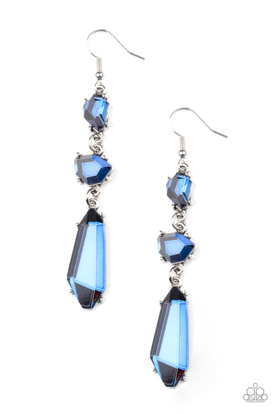 Sophisticated Smolder - Blue Earrings - Paparazzi Accessories Featuring raw cuts, an asymmetrical collection of faceted blue gems trickles from the ear, creating a smoldering chandelier. Earring attaches to a standard fishhook fitting.  Sold as one pair of earrings.  New Kit