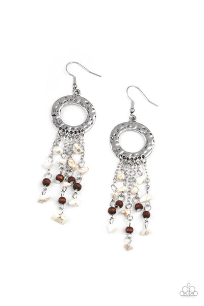 Primal Prestige - White Earrings - Paparazzi Accessories Tapered tassels of dainty wooden beads and white pebbles stream from the bottom of a hammered silver hoop, creating an earthy fringe. Earring attaches to a standard fishhook fitting.  Sold as one pair of earrings.  New Kit