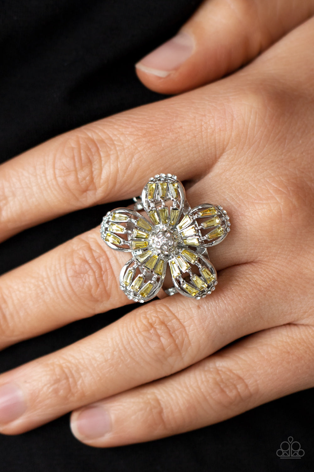 Botanical Ballroom - Yellow Ring - Paparazzi Accessories Yellow emerald-style rhinestones adorn the silver petals of a blooming flower featuring a white rhinestone encrusted beaded center. The tips of the colorful petals are dusted in dainty white rhinestones, adding extra shimmer to the sparkly centerpiece. Features a stretchy band for a flexible fit.  Sold as one individual ring.  New Kit