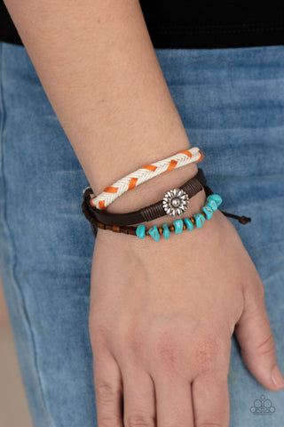 Terrain Trend - Orange Bracelet - Paparazzi Accessories Featuring a silver floral centerpiece, mismatched strands of turquoise stones and wooden beads, brown leather, and braided orange and white cording layers across the wrist for a seasonal flair. Features an adjustable sliding knot closure.  Sold as one individual bracelet.  New Kit