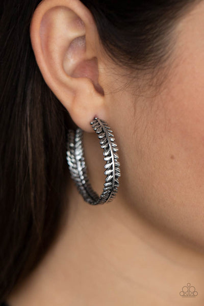 Laurel Gardens - Silver Hoop Earrings - Paparazzi Accessories Brushed in an antiqued shimmer, a leafy silver frame delicately curls into a whimsical hoop. Earring attaches to a standard post fitting. Hoop measures approximately 1 1/4" in diameter.  Sold as one pair of hoop earrings.  New Kit