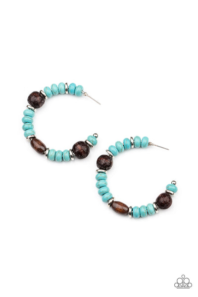 Definitely Down-To-Earth - Blue Earrings - Paparazzi Accessories An earthy collection of turquoise stone beads, silver discs, and brown wooden beads are delicately threaded along a dainty wire, creating an artisan inspired hoop. Earring attaches to a standard post fitting. Hoop measures approximately 2" in diameter.  Sold as one pair of hoop earrings.  New Kit