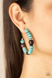 Definitely Down-To-Earth - Blue Earrings - Paparazzi Accessories An earthy collection of turquoise stone beads, silver discs, and brown wooden beads are delicately threaded along a dainty wire, creating an artisan inspired hoop. Earring attaches to a standard post fitting. Hoop measures approximately 2" in diameter.  Sold as one pair of hoop earrings.  New Kit