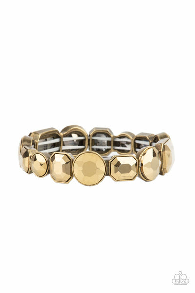 Extra Exposure - Brass Bracelet - Paparazzi Accessories Encased in sleek brass frames, a smoldering collection of round and emerald cut aurum rhinestones glide along stretchy bands around the wrist, creating a sparkly industrial statement piece.  Sold as one individual bracelet.  New Kit