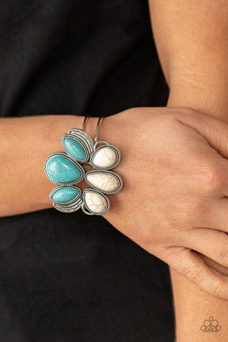 Botanical Badlands - White Bracelet - Paparazzi Accessories Encased in rope-like silver accents, a series of oversized oval and teardrop turquoise and white stone frames stack into a lotus-like floral frame atop a layered silver cuff. Features a hinged closure.  Sold as one individual bracelet.  New Kit