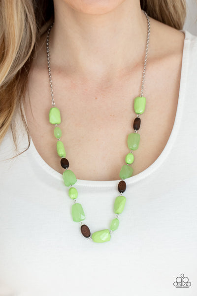 Meadow Escape - Green Necklace - Paparazzi Accessories Varying in opacity, a mixed assortment of faceted Apple Green beads delicately link with dainty wooden beads across the chest, creating a whimsically earthy display. Features an adjustable clasp closure.  Sold as one individual necklace. Includes one pair of matching earrings.  New Kit