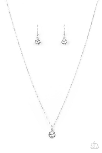 Undeniably Demure - White Necklace - Paparazzi Accessories A glittery white rhinestone is fitted inside a pronged silver frame, creating a dramatically timeless pendant below the collar. Features an adjustable clasp closure.  Sold as one individual necklace. Includes one pair of matching earrings.  New Kit