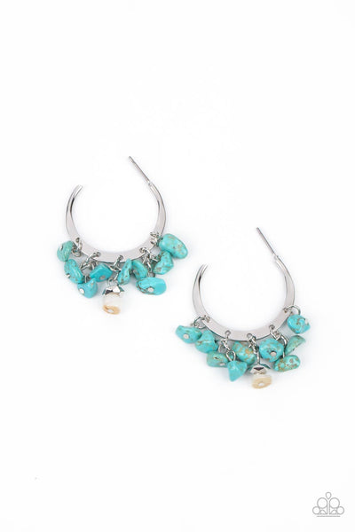 Gorgeously Grounding - Blue Earrings - Paparazzi Accessories of turquoise pebbles swing from the bottom of a dainty silver hoop, creating an earthy fringe. A faceted silver and white stone bead swings from the center, adding an ethereal edge. Earring attaches to a standard post fitting. Hoop measures approximately 1 1/4" in diameter.  Sold as one pair of hoop earrings.  New Kit