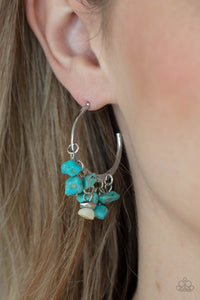 Gorgeously Grounding - Blue Earrings - Paparazzi Accessories of turquoise pebbles swing from the bottom of a dainty silver hoop, creating an earthy fringe. A faceted silver and white stone bead swings from the center, adding an ethereal edge. Earring attaches to a standard post fitting. Hoop measures approximately 1 1/4" in diameter.  Sold as one pair of hoop earrings.  New Kit