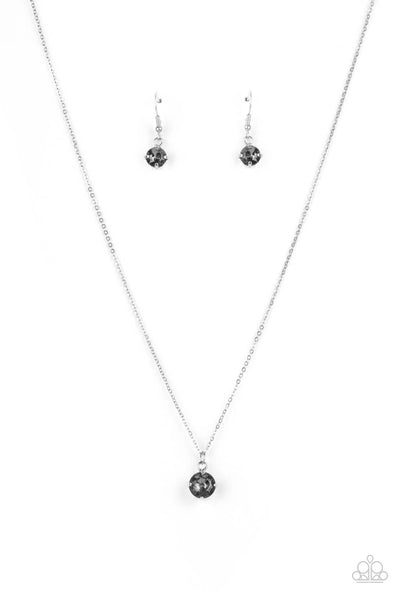 Undeniably Demure - Silver Necklace - Paparazzi Accessories A smoky rhinestone is fitted inside a pronged silver frame, creating a dramatically timeless pendant below the collar. Features an adjustable clasp closure.  Sold as one individual necklace. Includes one pair of matching earrings.  New Kit