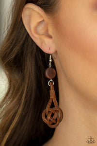 Twisted Torrents - Brown Earrings - Paparazzi Accessories Brown wicker-like laces delicately twist into a knotted frame that attaches to a dainty brown wooden disc, creating an earthy display. Earring attaches to a standard fishhook fitting.  Sold as one pair of earrings.  New Kit