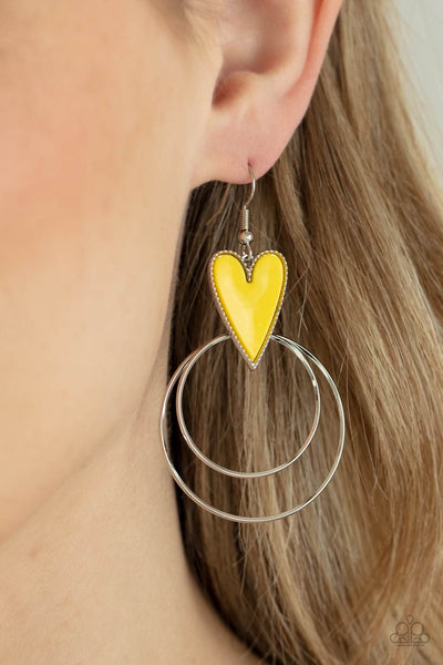 Happily Ever Hearts - Yellow Earrings - Paparazzi Accessories Dainty silver hoops attach to the bottom of a playful Illuminating heart frame, creating a flirtatious pop of color. Earring attaches to a standard fishhook fitting.  Sold as one pair of earrings.  New Kit