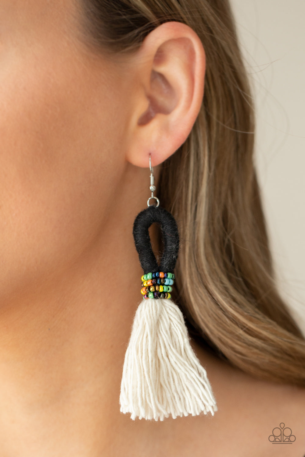 The Dustup - Black Earrings - Paparazzi Accessories A tassel of soft white cotton fans out under rows of brightly colored seed beads. Anchored by a loop of jet black floss, the eye-catching style swings from the ear for a show-stopping statement. Earring attaches to a standard fishhook fitting.  Sold as one pair of earrings.  New Kit