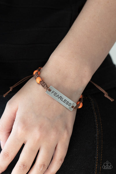 Conversation Piece - Orange Bracelet - Paparazzi Accessories A silver plate engraved with the word "FEARLESS" is centered between brown knotted cording. Accented with bright orange stone beads, it slides around the wrist for an unconventional conversation starter. Features an adjustable sliding knot closure.  Sold as one individual bracelet.  New Kit