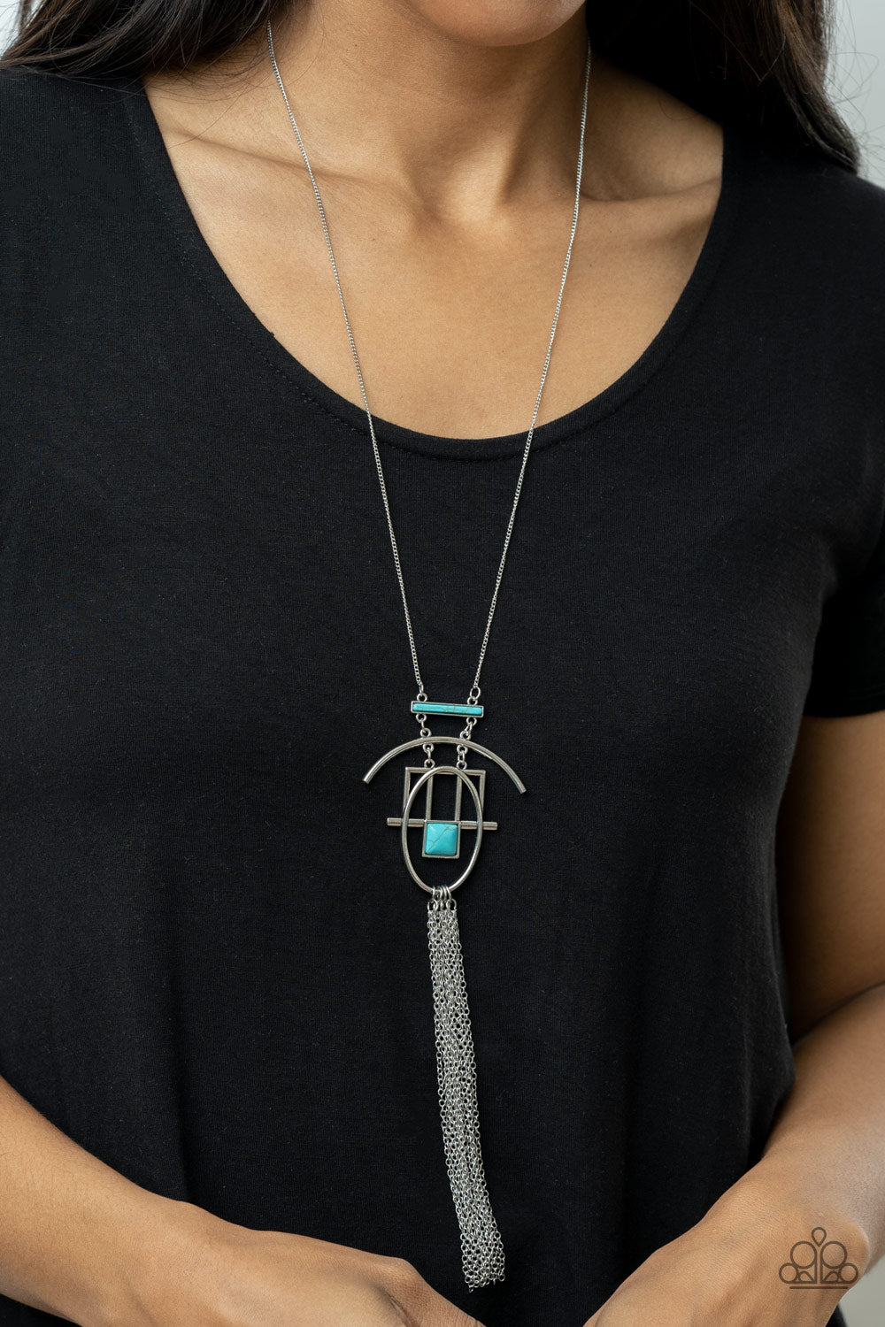 Eco Echoes - Blue Necklace - Paparazzi Accessories Infused with refreshing turquoise stone accents, shiny silver bars link and connect into stacked geometric frames at the bottom of a lengthened silver chain. A shimmery silver chain tassel streams from the bottom of the stacked pendant, adding a free-spirited finish to the artisan inspired talisman. Features an adjustable clasp closure.  Sold as one individual necklace. Includes one pair of matching earrings.  New Kit