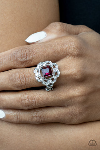 Candid Charisma - Pink Ring - Paparazzi Accessories An airy flower-petal frame encrusted with brilliant white rhinestones highlights a stunning square-cut pink gem. Set in silver pronged fittings the timeless gem sits center stage creating a charismatic display atop the finger. Features a dainty stretchy band for a flexible fit.  Sold as one individual ring.  New Kit