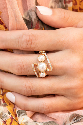 Posh Progression - Gold Ring - Paparazzi Accessories A golden ribbon of white rhinestones whirls around and behind a single band of three bubbly white pearls, coalescing into a timeless twinkle atop the finger. Features a dainty stretchy band for a flexible fit.  Sold as one individual ring.  New Kit Fashion Fix