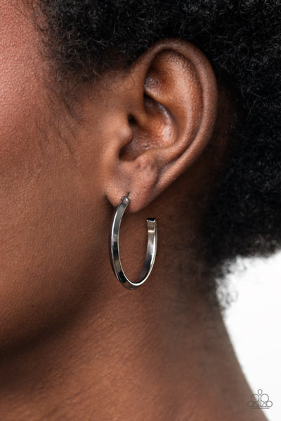 On The Brink - Black Earrings - Paparazzi Accessories A raised spine on a shiny gunmetal hoop creates a dramatic finish to the simple design. Earring attaches to a standard post fitting. Hoop measures approximately 1" in diameter.  Sold as one pair of hoop earrings.  New Kit