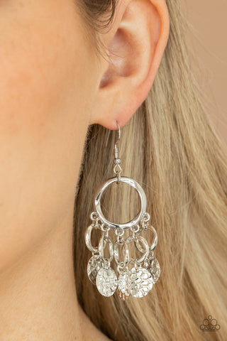 Partners in CHIME - Silver Earrings - Paparazzi Accessories Embossed in tactile geometric patterns, shiny silver discs swing from the bottom of dainty silver rings at the bottom of an asymmetrical silver ring for a noise-making fashion. Earring attaches to a standard fishhook fitting.  Sold as one pair of earrings.  New Kit