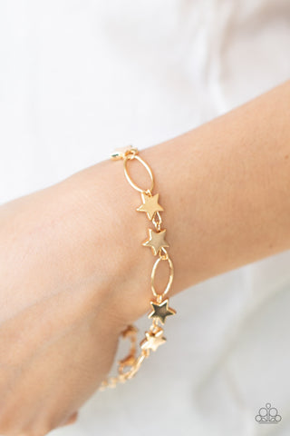 Stars and Sparks - Gold Bracelet - Paparazzi Accessories Dainty gold stars and airy gold ovals delicately link around the wrist, creating a stellar 4th of July display. Features an adjustable clasp closure.  Sold as one individual bracelet.  New Kit