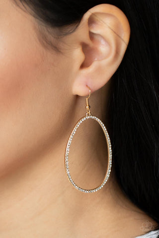 OVAL-ruled! - Gold Earrings - Paparazzi Accessories Dotted in dainty white rhinestones, an asymmetrical oval gold frame swings from the ear for a sassy look. Earring attaches to a standard fishhook fitting.  Sold as one pair of earrings.  New Kit