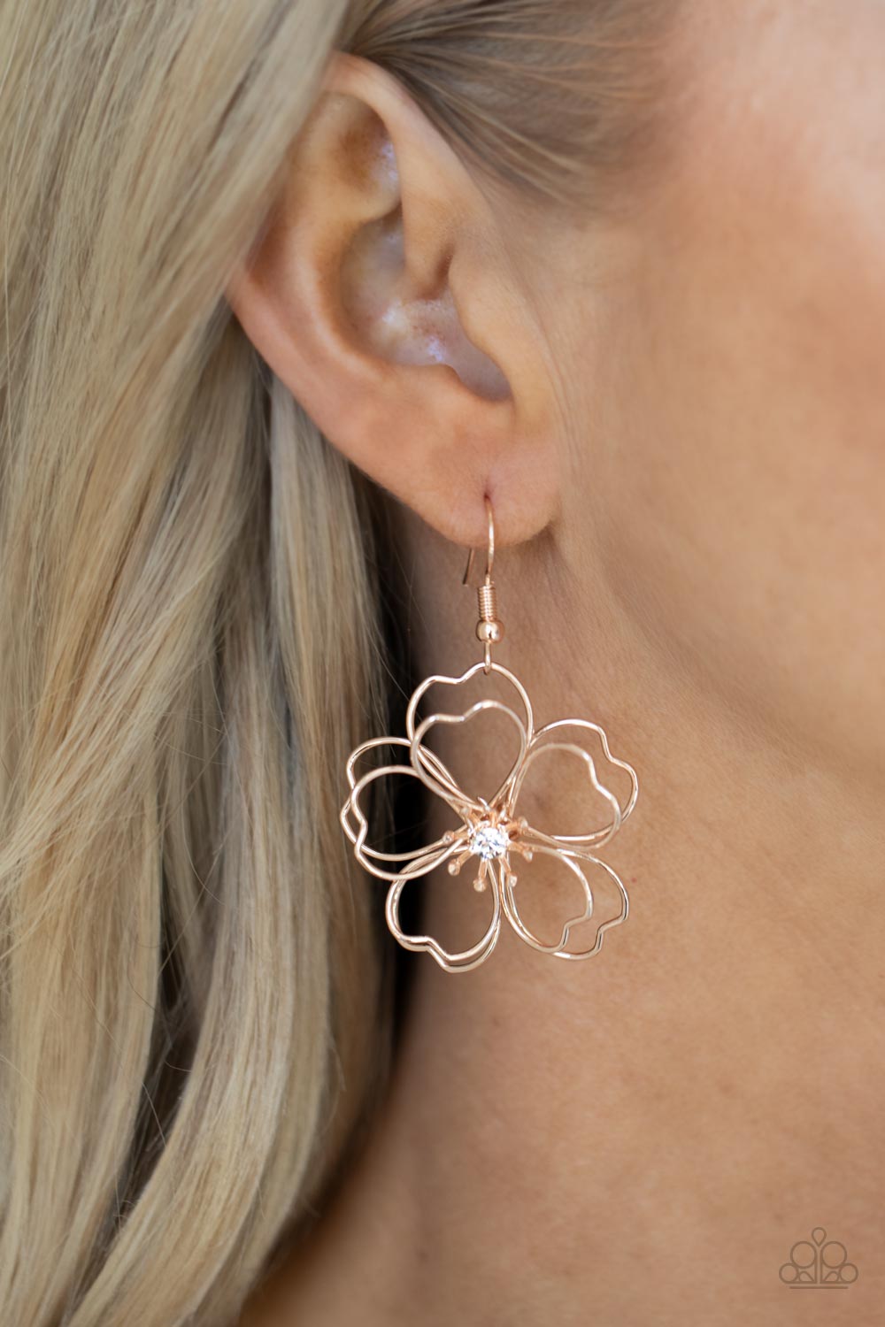 Petal Power - Rose Gold Earrings - Paparazzi Accessories Layers of heart-shaped petals molded from shiny rose gold wire create an airy three-dimensional flower. A dainty white rhinestone dots the center adding sparkle to the whimsical frame. Earring attaches to a standard fishhook fitting.  Sold as one pair of earrings.  New Kit