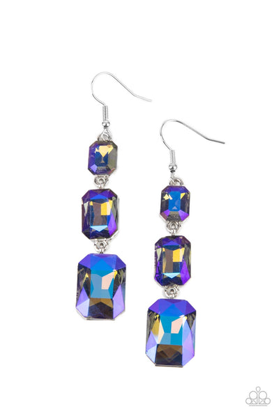 Cosmic Red Carpet - Blue Earrings - Paparazzi Accessories  Featuring a dazzling blue and gold UV shimmer, a trio of emerald-cut gems in graduating sizes is linked one below the other for a dramatic red carpet finish. Earring attaches to a standard fishhook fitting.  Sold as one pair of earrings.  New Kit