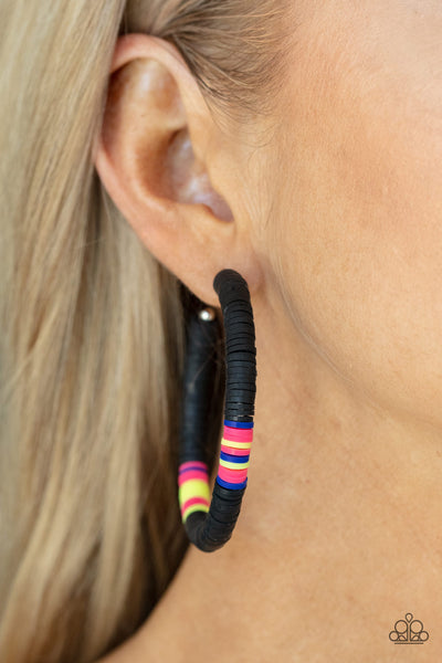 Colorfully Contagious - Black Earrings - Paparazzi Accessories Rubbery black, pink, blue, and yellow bands are threaded along an oversized silver hoop, creating a courageous pop of color. Earring attaches to a standard post fitting. Hoop measures approximately 2 1/4" in diameter.  Sold as one pair of hoop earrings.  New Kit