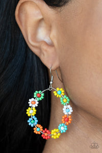 Festively Flower Child - Multi Earrings - Paparazzi Accessories Dotted with mismatched multicolored beaded centers, a dainty collection of multicolored seed beaded floral frames are threaded along a wire hoop for a fabulous floral fashion. Earring attaches to a standard fishhook fitting.  Sold as one pair of earrings.  New Kit